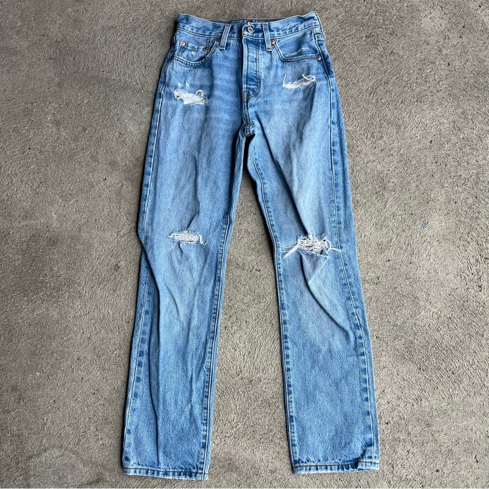 Light-wash distressed Levi’s 501 jeans